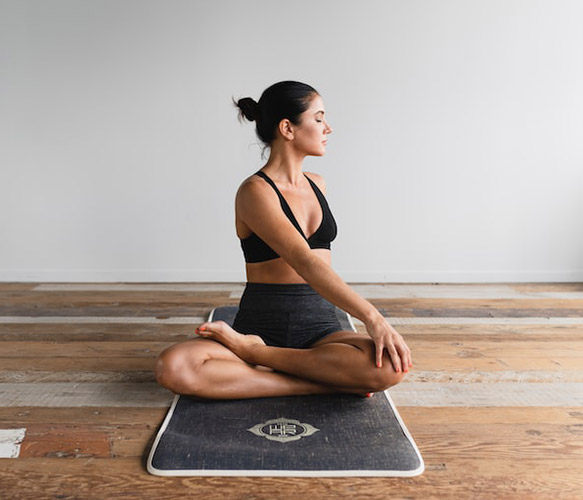 woman sitting on yoga mat