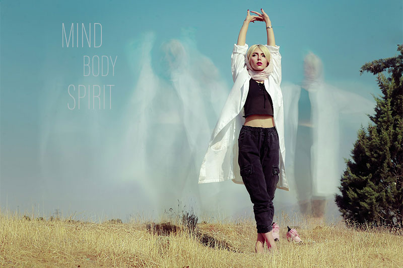 woman in a yoga pose with spirit floating above